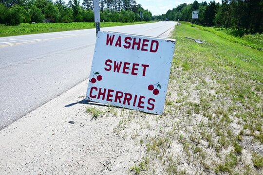 sweet washed cherries sign off a rural highway in northern Michigan during the summer, local business