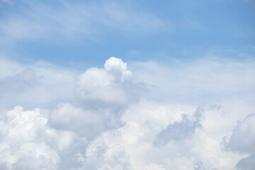 Fototapeta premium fluffy white clouds building up in the light blue sky