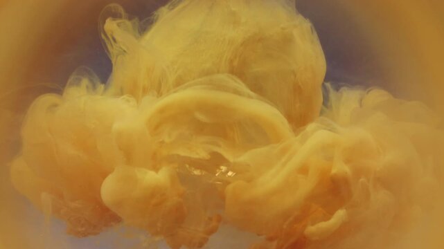 Defocused pour. Mist paint. Yellow pigment dripping color water blur vapor splash. Dye blob on glass crystal drop abstract round frame gray background.