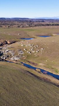 Aerial View of Rural Australian Landscape with Granite Boulders and Creek
