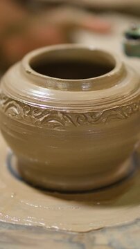 Close Up of Intricate Clay Pot Spinning on Pottery Wheel