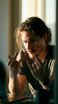 Sunlight frames a thoughtful man's intense gaze