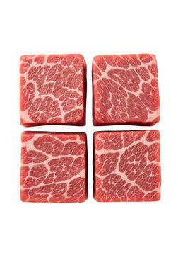 Four raw wagyu beef cubes with beautiful marbling arranged in a square pattern for cooking isolated on transparent background