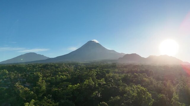 Aerial footage of Mount Merapi and Mount Merbabu in the morning. Blue skies and clear weather. Tropical landscape.