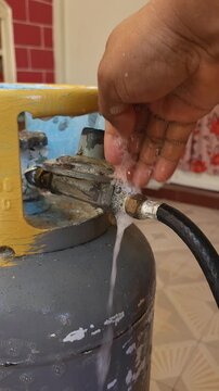Applying Soapy Water to Propane Gas Tank Valve to Detect Leaks