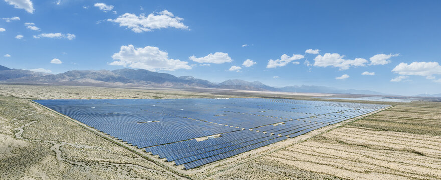 Aerial View of Large Solar Power Station in arid desert terrain﻿
