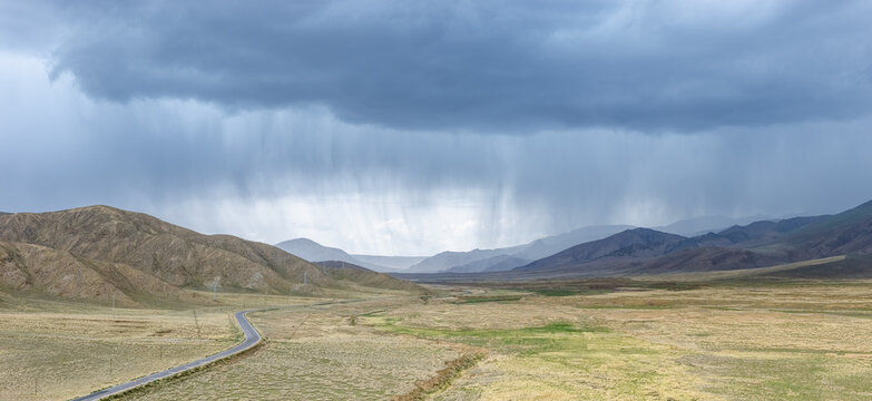 Dramatic Rain Storm Over Arid Mountain Valley Landscape