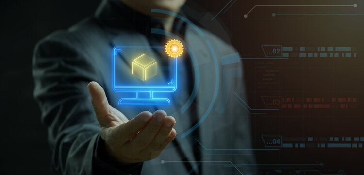 Businessman open hand supporting glowing computer screen icon displaying 3D cube model. Rapid prototyping simulation, digital product design development, and engineering modeling concept.