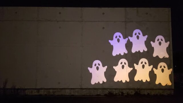 Ghost shadow projection on concrete wall at night