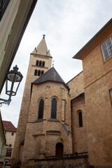 Fototapeta premium Looking up at towers of a church or castle in Europe; historic streets
