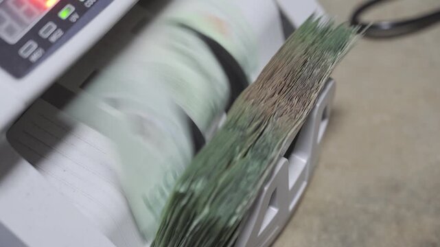selective focus close up to Money counting machine in motion while bank note were counting action. Banking operation with money Business concept with money. Counting machine for money theme.