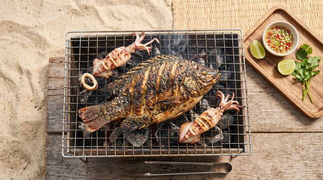 Grilled fish and squid on the hot grill