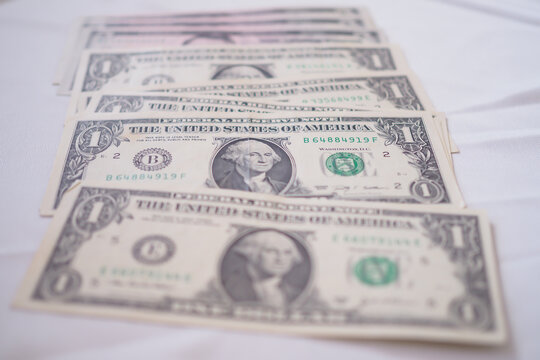 USD currency , Many dollar bank notes Placed on the table.The  Dollar is the currency of USA that is used to change, buy, sell, accumulate, and invest in united kingdom's state people.