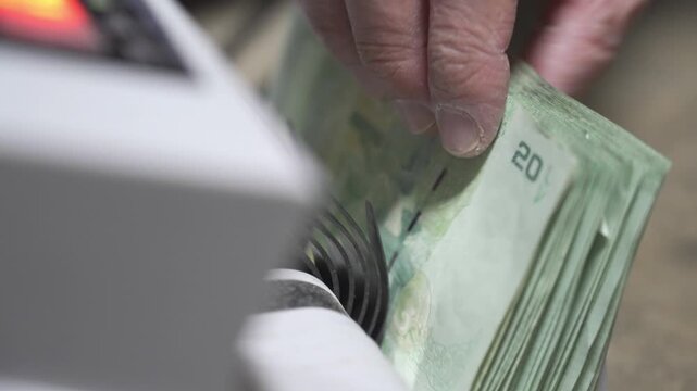 selective focus close up to Money counting machine in motion while bank note were counting action. Banking operation with money Business concept with money. Counting machine for money theme.