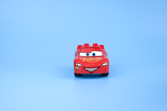 Front view of a Lightning McQueen toy car positioned on a light blue background with the smiling face centered toward the camera on Jul 29, 2026 in Jakarta, Indonesia.