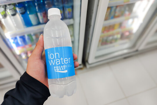 Person holding a bottle of Pocari Sweat Ion Water isotonic drink in front of a supermarket refrigerator display. Pangandaran Indonesia, 2 August 2026