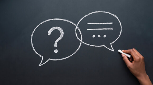Hand drawing speech bubbles with a question mark and answers on a chalkboard. FAQ, support, and business communication concept