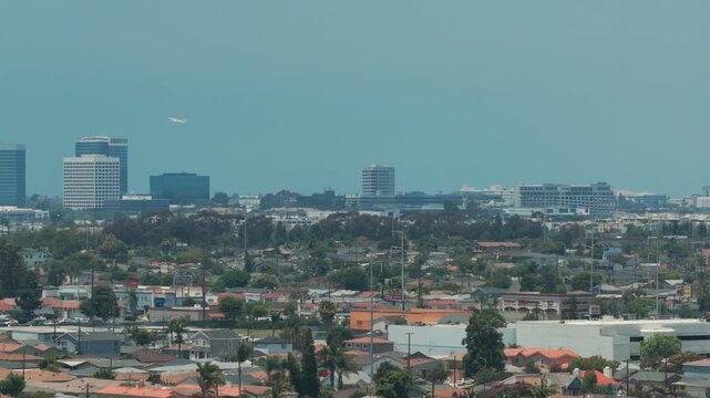 Telephoto dolly shot of an airplane taking off from LAX in Los Angeles, California. 4K