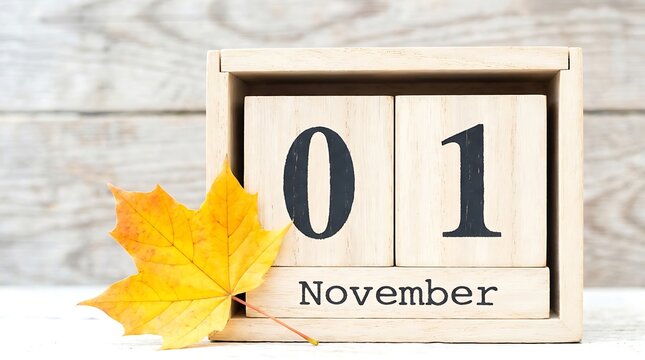 Wooden calendar blocks showing november 1st with autumn leaf november calendar