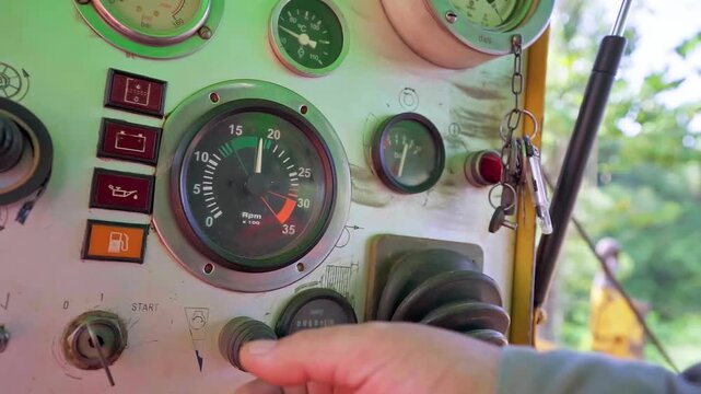 Close-up of an operator controlling machinery used for fiber optic cable installation during broadband network deployment in Minas Gerais, Brazil. Telecommunications infrastructure and modern connecti
