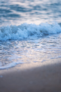 Vertical landscape image of sea wave splashing on beach