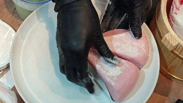 Dusting with starch on mochi wrapped strawberry basque cheesecake.