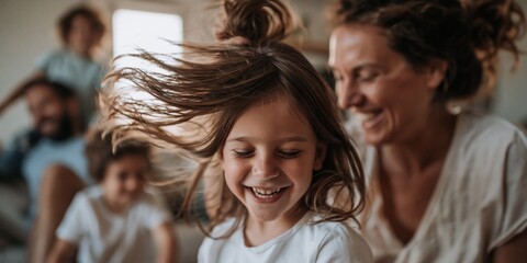 Obraz premium Joyful family enjoying a playful moment indoors with laughter and flying hair