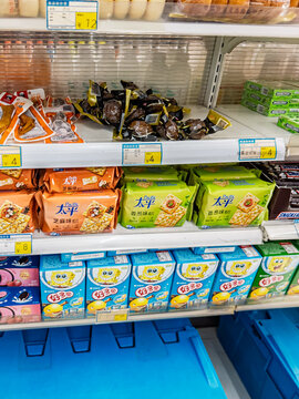 Packaged crackers, SpongeBob-themed snacks, and local Chinese delicacies line the shelves of a convenience store in Shanghai, China, on May 25, 2026.