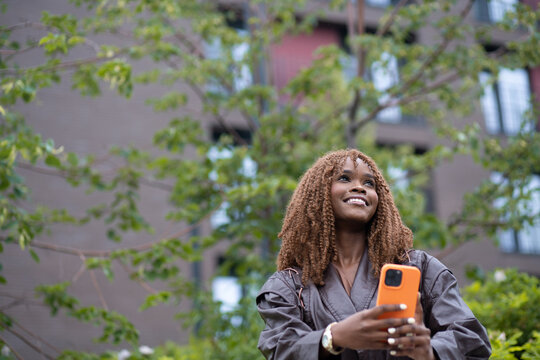 A woman using a mobile phone standing outdoors