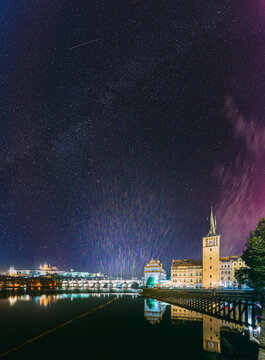 Vltava river bridges beneath a rare pink aurora in Prague