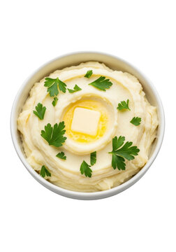 Creamy mashed potatoes in a bowl with a melting piece of butter and fresh green parsley herbs isolated on transparent background