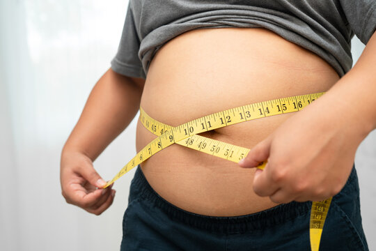Asian woman with fat belly big size overweight and obesity with measure tape.