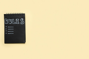 Fototapeta premium Notebook with blank list of rules on beige background