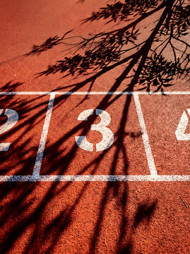 Red running track lane markings with number three on transparent background