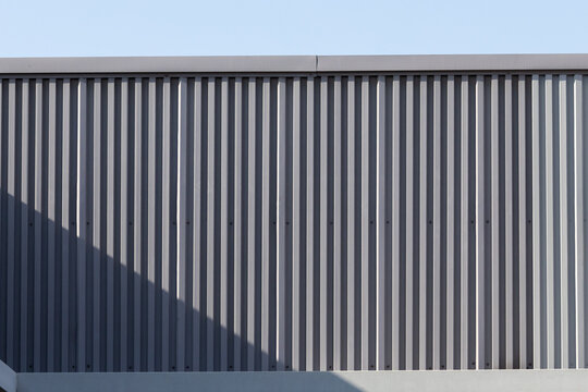 Close-up of textured metal siding under clear sky