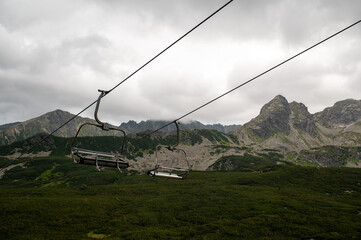 Empty chairlift hangs over summer mountain valley © Cavan