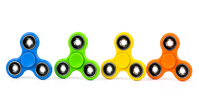Four colorful plastic fidget spinners in a row