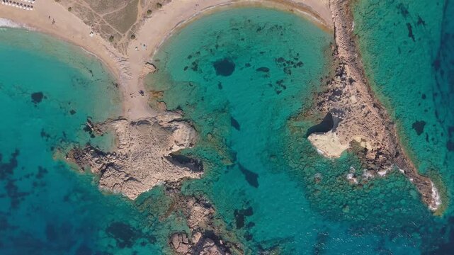 Top-down drone shot revealing the crystal-clear turquoise waters of Lefkos Beach in Karpathos, showcasing the pristine shoreline and the vibrant colors of the Aegean Sea.