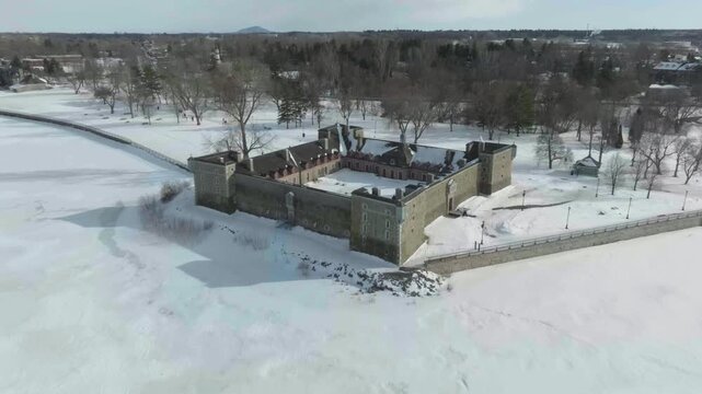 drone zoom out of the castle fort chambly in quebec canada in a sunny day exposing river richeleau