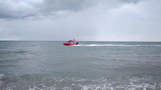 Rough Sea Waves Rolling onto Empty Dark Sand Shoreline on Cloudy Day