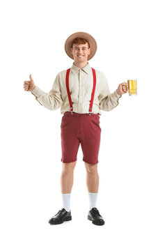 Young man in traditional German clothes with beer showing thumb-up on white background