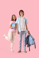 Fototapeta premium Couple of teenage student on pink background
