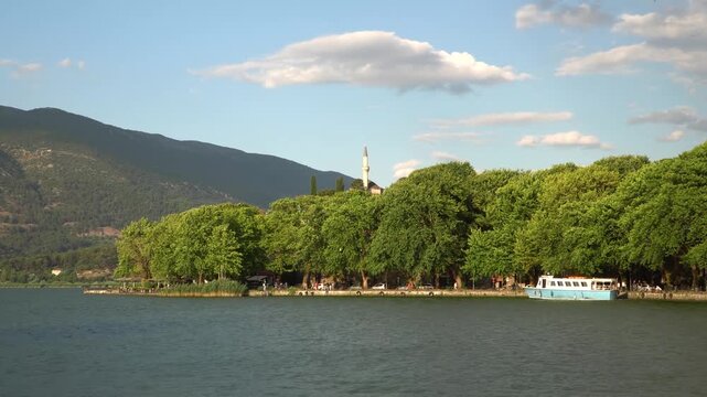 Boat Trip to Lake Island in Ioannina Greece, Old city Castle, Nature and Aslan Pasha Museum in Background, Wide View Fast Forward Shot