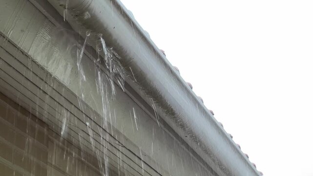 Heavy Rain Overflowing from a Roof Gutter