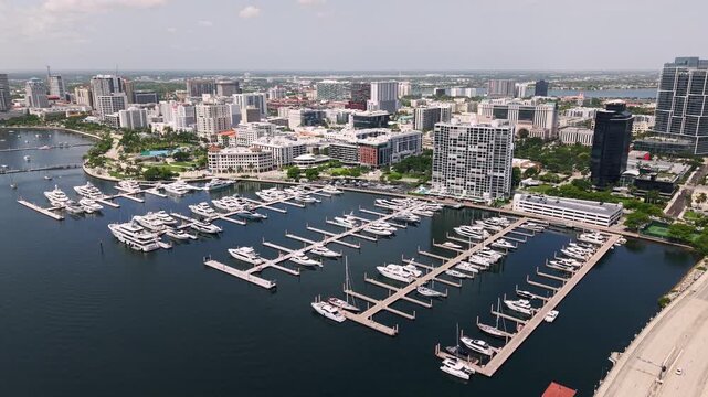 West Palm Beach harbor and marina with downtown skyline, aerial medium establishing dolly