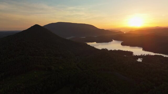Morning light crosses dark mountain slopes and a calm lake in Tennessee.
