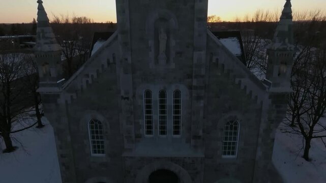 drone asending overlooking the bigest church in chambly quebec canada from main fllor n doors to the top main cross n cementery in the back