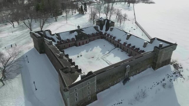 drone zooming out from fort castle chambly in quebec canada in a sunny day incluiding the river richeleau