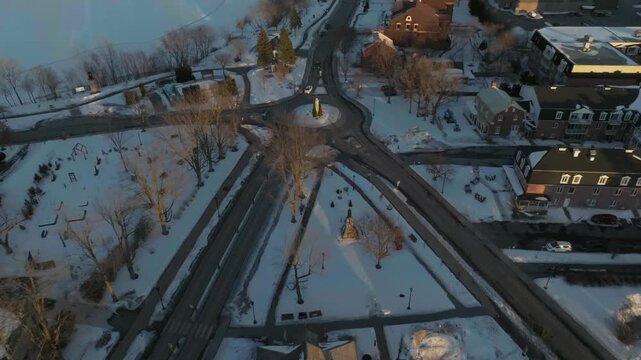 drone flying over the main street of the city of chambly quebec canada in winter exposing the monuments n the city hall main library coast line n the lighthouse