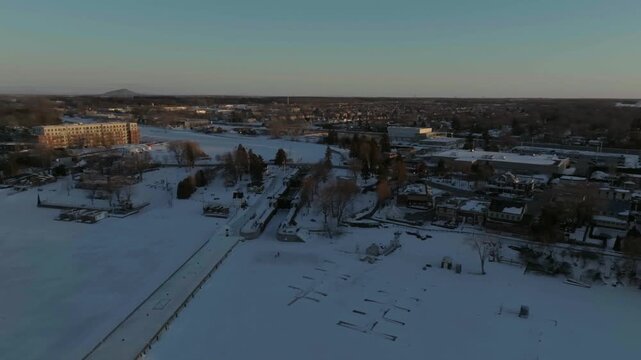 drone flying around the chambly channel a historic site of canada in winter exposing the site n the coastline of the river richelieau